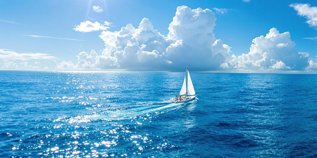 Segelboot auf ruhiger See unter blauem Himmel.